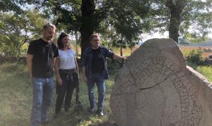Charlotte Hedenstierna-Jonson, John Ljungkvist and Neil Price at runestone Vs 1.